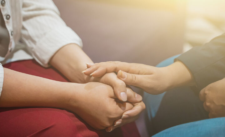 woman comforting another woman